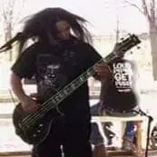 Guitarist with long hair performing outdoors in Roswell, New Mexico. | MOON MUTT Recording Studio