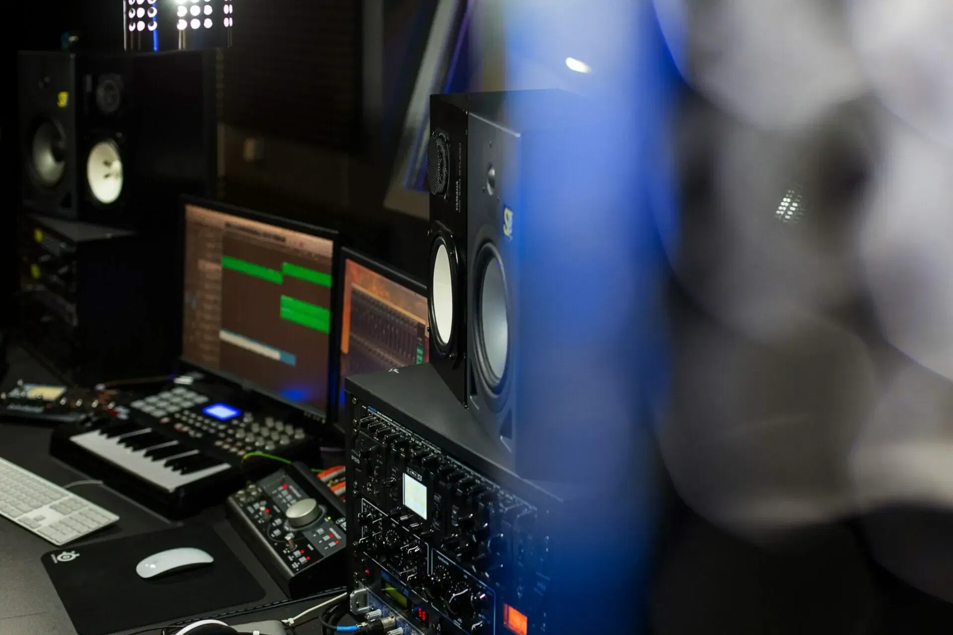 Music production equipment including speakers, an audio interface, and a midi keyboard is ready for musicians in the MOON MUTT Recording Studio setup. | MOON MUTT Recording Studio