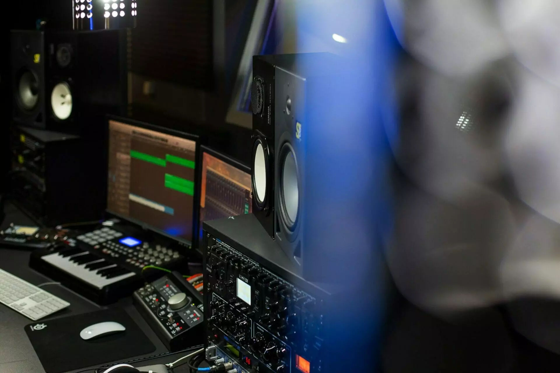 Music production equipment including speakers, an audio interface, and a midi keyboard is ready for musicians in the MOON MUTT Recording Studio setup. | MOON MUTT Recording Studio